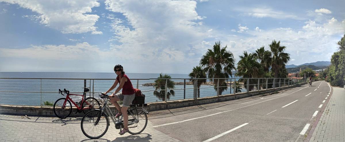 Bikes on the palm-lined coast road below Cipressa