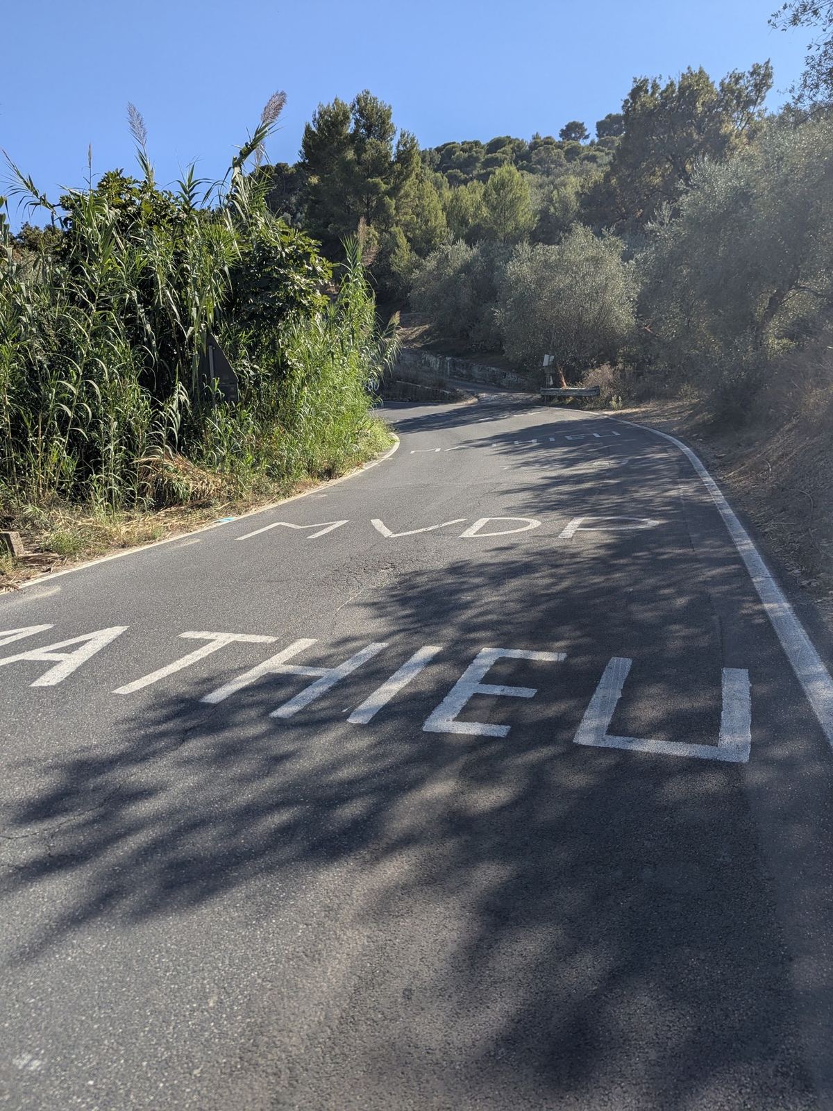 The name MATHIEU painted in white on the road surface of the Cipressa climb
