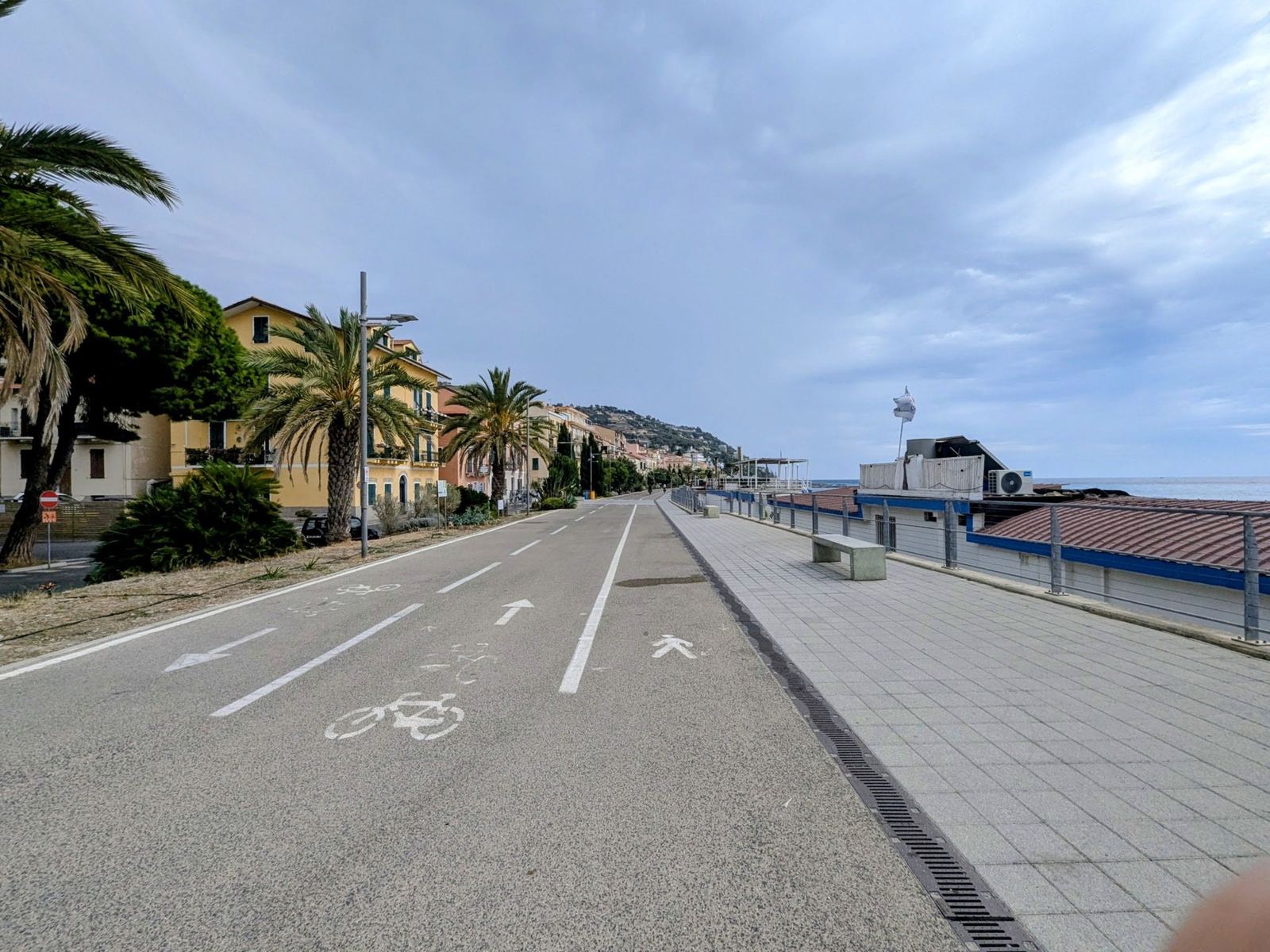 The wide cycle path along the sea front with the town behind