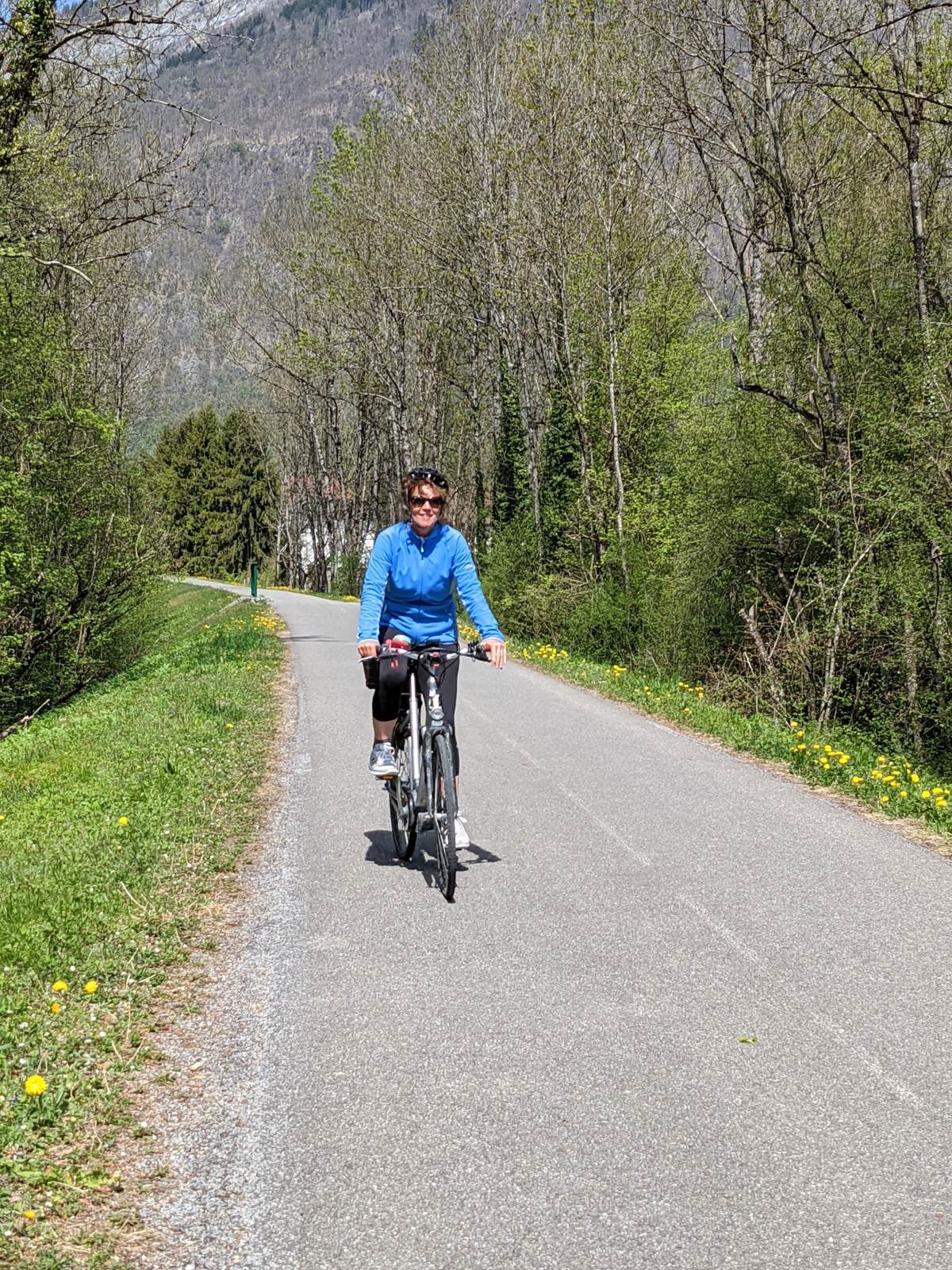 My wife cycling a flat valley path near Beaufort in the French Alps