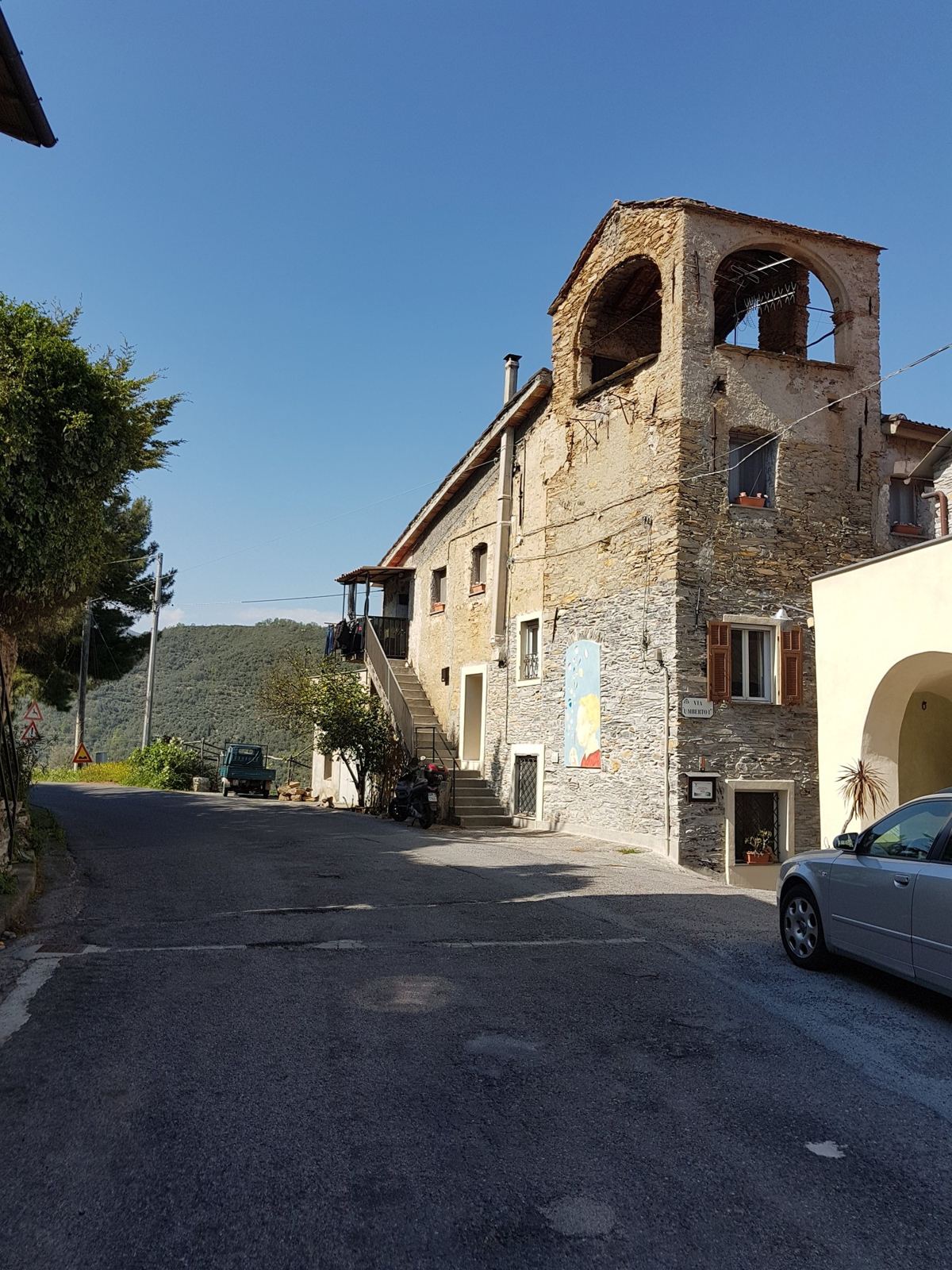 An old stone tower house beside the road in the hills above Dolcedo