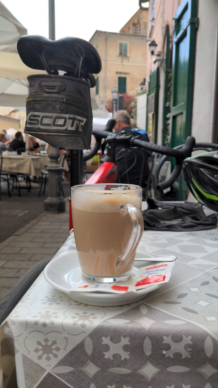 A coffee and a Garmin on a café table in Dolcedo