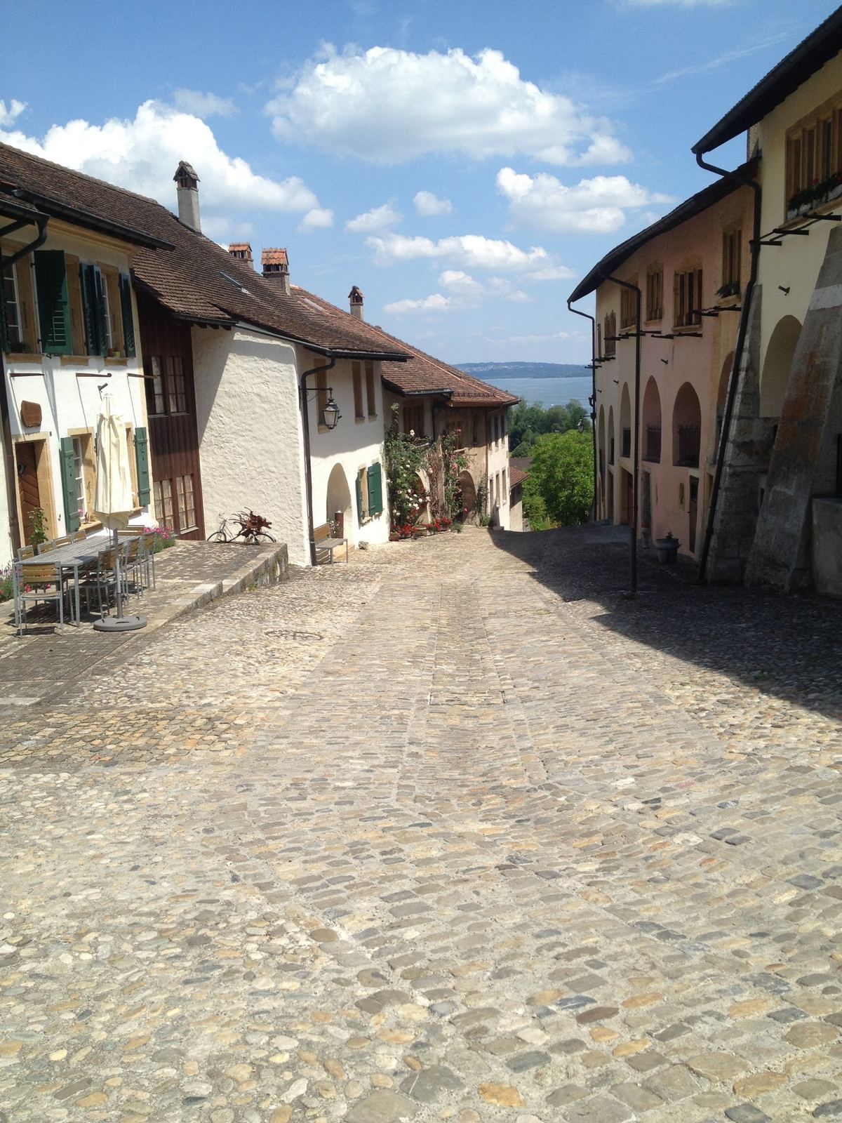 The cobbled old-town street of Erlach climbing between old stone houses