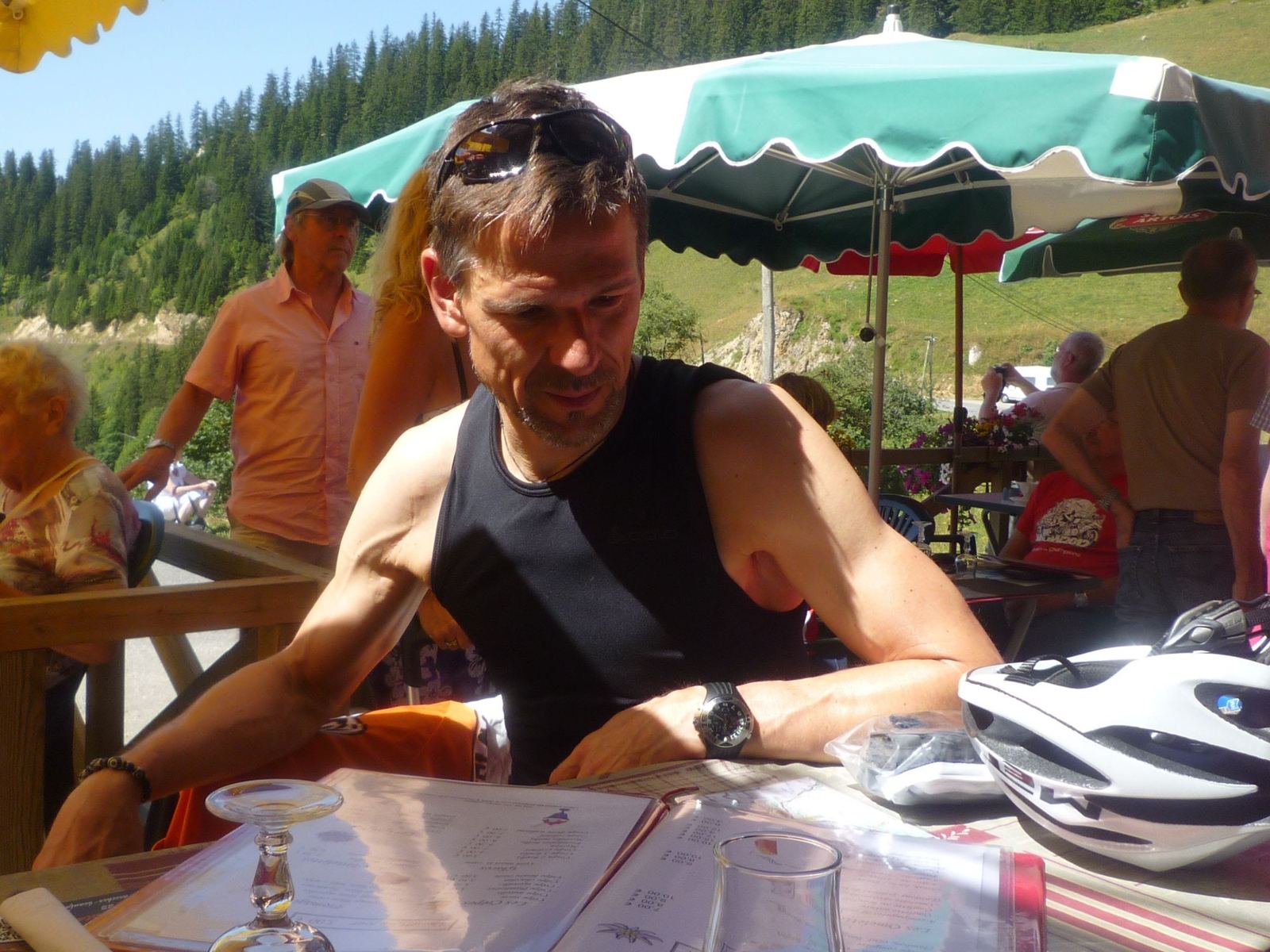 Cyclists at lunch on a terrace by the Lac de Roselend