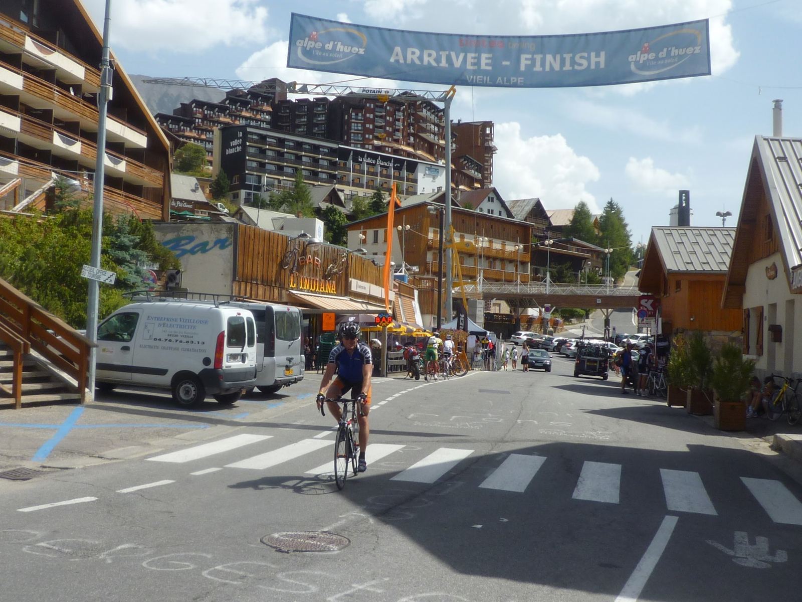 The resort of Alpe d'Huez with banners across the road and riders arriving