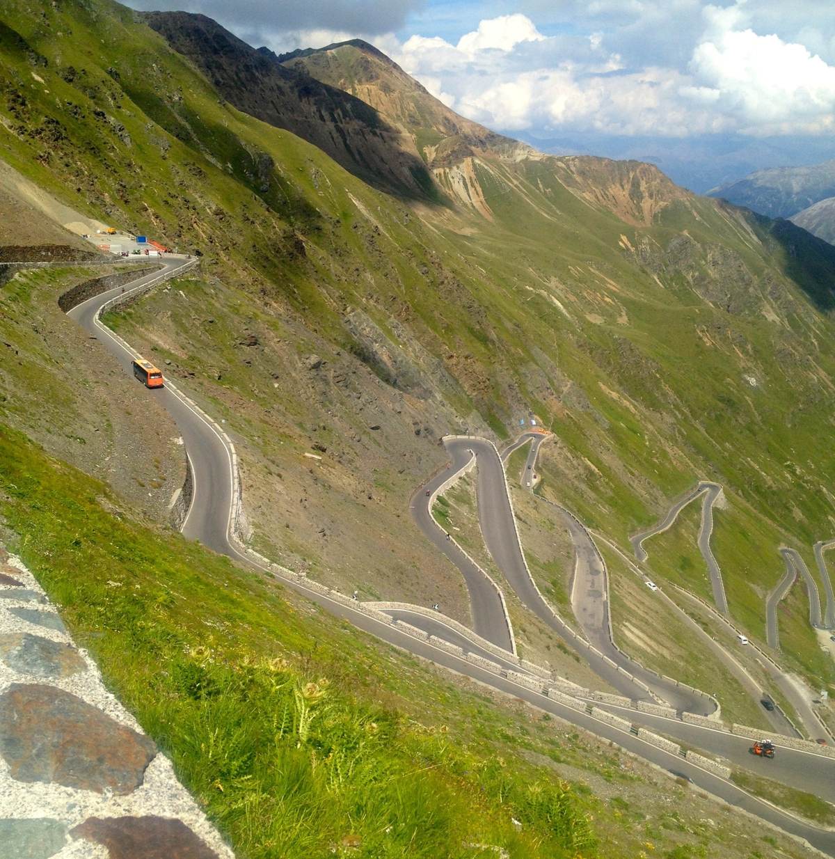 The Stelvio hairpins winding down the mountainside, seen from above