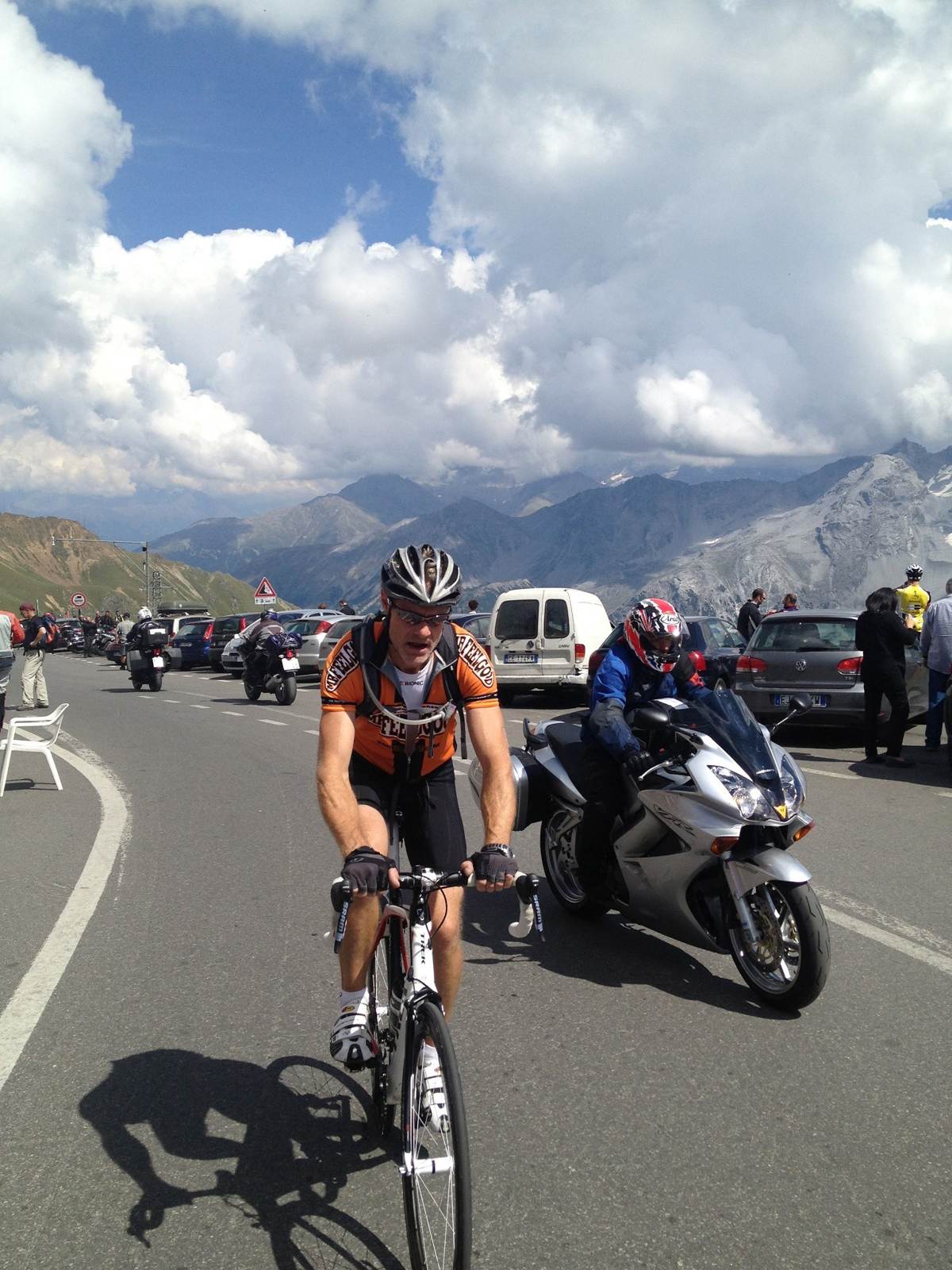 Me riding across the top of the Stelvio Pass with a motorbike alongside