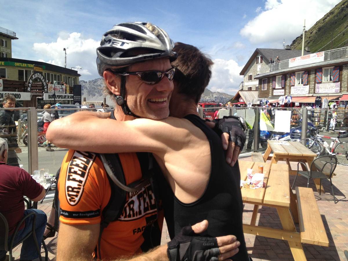 Me celebrating with a riding companion at the summit of the Stelvio Pass
