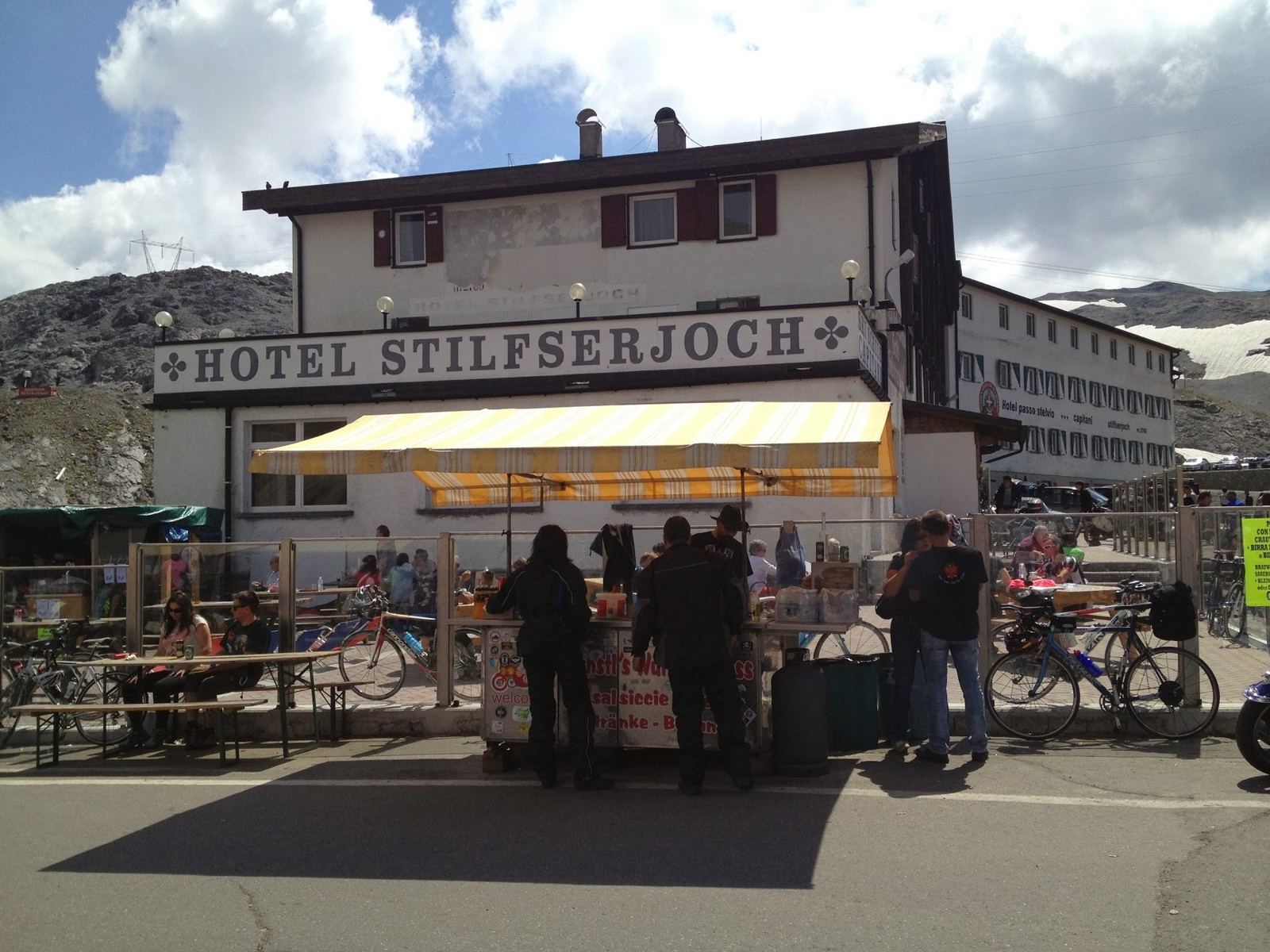 The Hotel Stilfserjoch at the top of the Stelvio, with riders and walkers outside