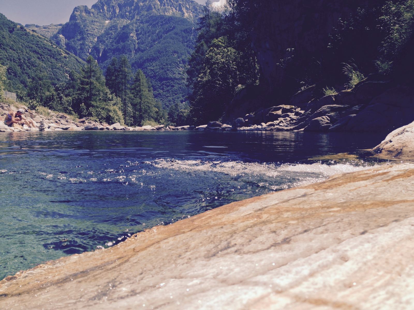 A clear green pool in the river near Sonogno, a swimming spot