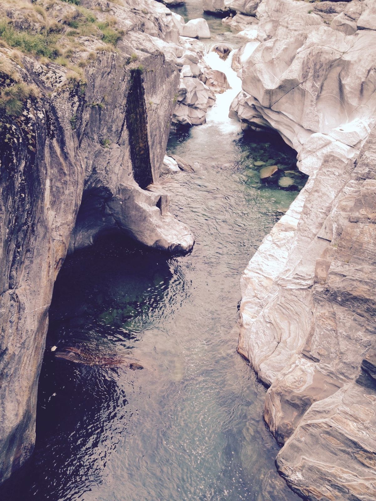 A deep green pool in a narrow white granite gorge on the Verzasca