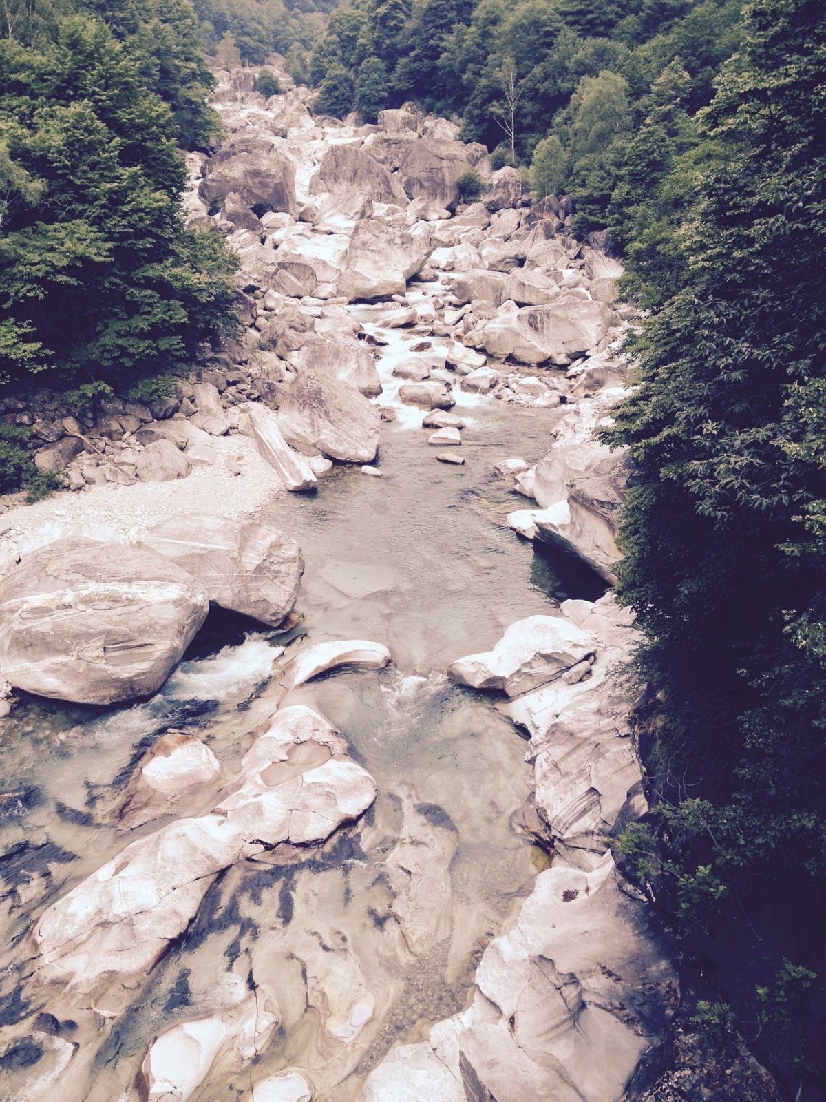 White granite boulders in the Verzasca river gorge with water running between them