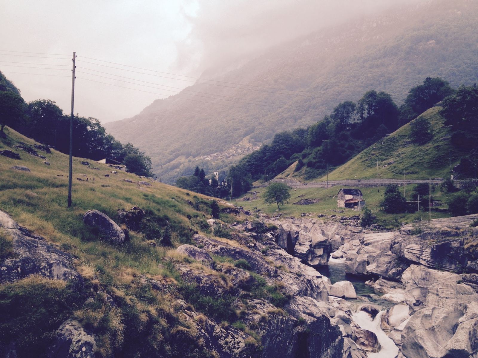 The Verzasca valley with the river running through rocks and steep green mountains rising on both sides